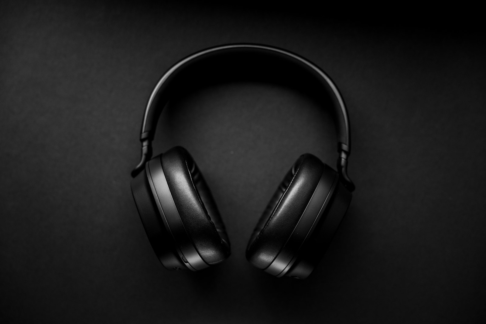 Black over-ear headphones on a dark surface